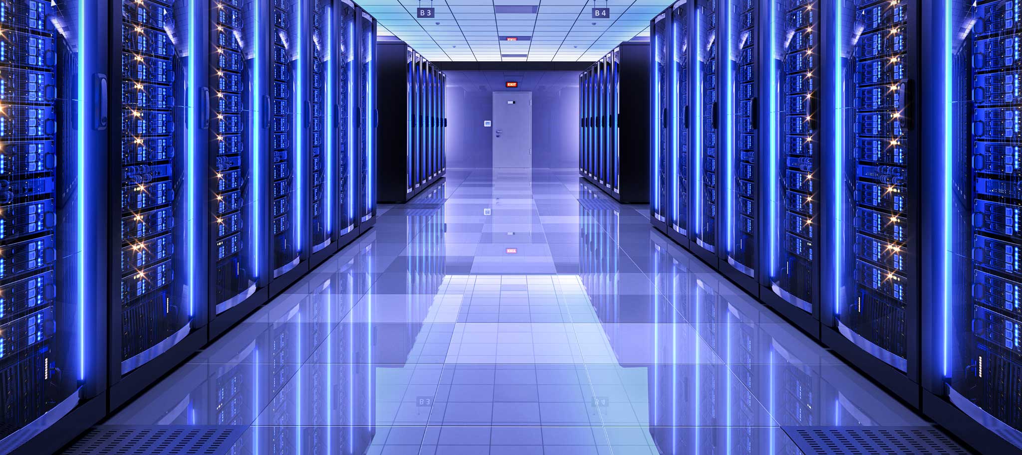 Hallway with glowing blue server racks in a data center.